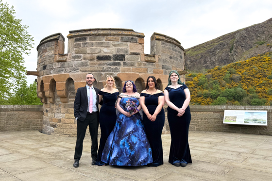 Smiling Wedding Party Posing Salisbury Crags Edinburgh by Let's Do It Creative